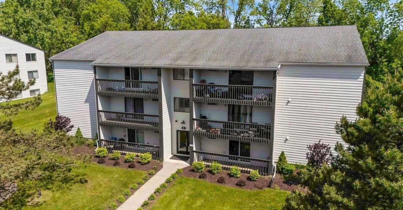 A low aerial view of a three storey apartment building at Remington Apartments after exterior work