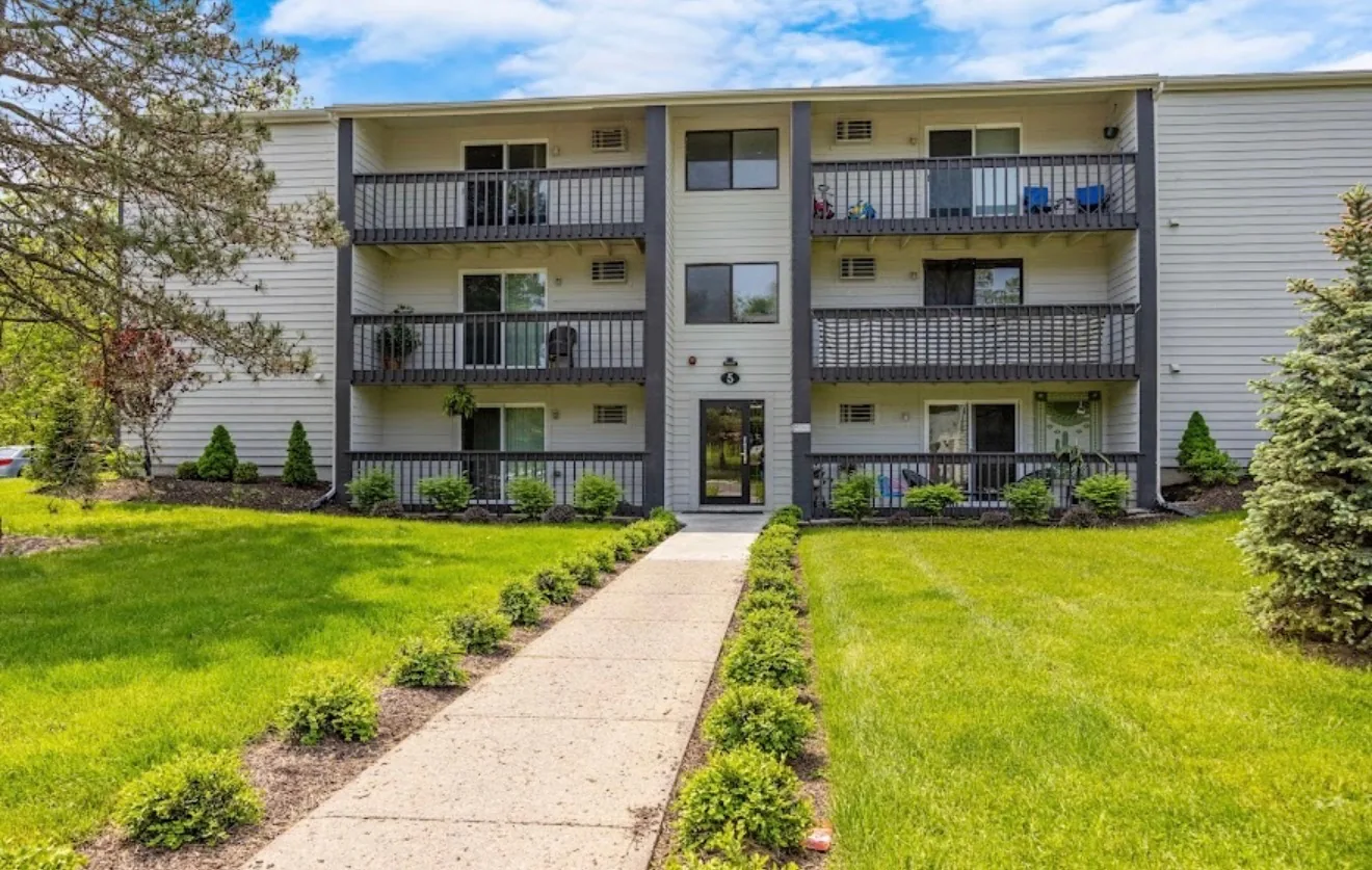 The entrance elevation of building five at Remington Apartments, with balconies and new planting
