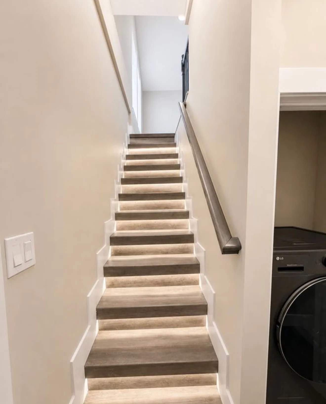 A staircase with a light strip set under every tread nosing